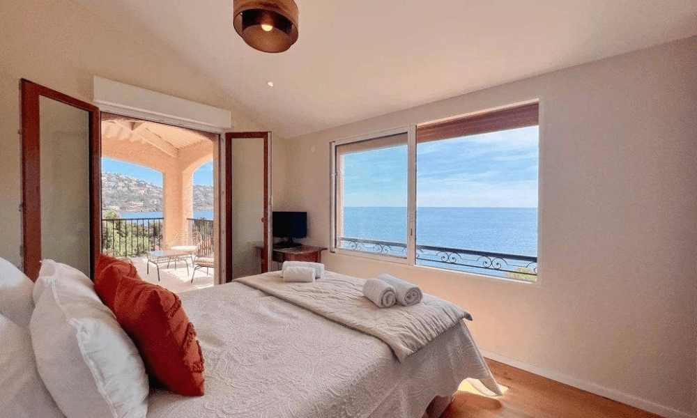 Designer dining area opening to terrace and sea views